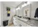 Elegant bathroom with dual sinks, granite countertops, and stylish lighting fixtures at 8317 E Via De La Escuela --, Scottsdale, AZ 85258