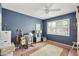 Bedroom features a ceiling fan, window, hardwood floors, and space for music instruments at 8317 E Via De La Escuela --, Scottsdale, AZ 85258