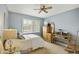 Serene bedroom with light blue walls, a ceiling fan, and a well-lit desk area with wicker chair at 8317 E Via De La Escuela --, Scottsdale, AZ 85258