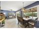 Stylish living room with a dining table, view of the pool, modern lighting, and comfortable seating at 8317 E Via De La Escuela --, Scottsdale, AZ 85258