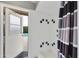 Shower room featuring white tiles and a decorative shower curtain, with a door leading outside at 8317 E Via De La Escuela --, Scottsdale, AZ 85258