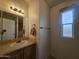 Bathroom featuring a vanity with a sink, a mirror, and a window with bright light at 8700 E University Dr # 953, Mesa, AZ 85207