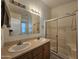 Bathroom features a double sink vanity with modern fixtures, a glass-enclosed shower, and neutral tones at 8700 E University Dr # 953, Mesa, AZ 85207