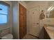 Bathroom with toilet and vanity, features wooden storage cabinets and natural light from a window with blue sky view at 8700 E University Dr # 953, Mesa, AZ 85207