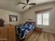 Cozy bedroom with vaulted ceiling, quilt bed, and wood-look flooring, offering a peaceful retreat at 8700 E University Dr # 953, Mesa, AZ 85207
