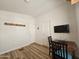 Bedroom showing a laptop on a wooden desk with a view of doors and a wall-mounted TV at 8700 E University Dr # 953, Mesa, AZ 85207
