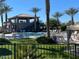 Relaxing community pool area featuring a gazebo, palm trees, lounge chairs, and well-manicured green lawns at 8700 E University Dr # 953, Mesa, AZ 85207