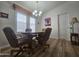 Cozy dining area with a round table, comfortable chairs, chandelier and natural light from the window with shutter blinds at 8700 E University Dr # 953, Mesa, AZ 85207