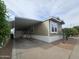 Charming home exterior with mature trees and a covered carport to protect from the elements at 8700 E University Dr # 953, Mesa, AZ 85207