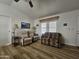 Comfortable living room featuring recliner chairs and sofa with desert pattern, complemented by natural light and wood-look flooring at 8700 E University Dr # 953, Mesa, AZ 85207