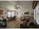 Inviting living room features a cozy sofa, recliner chairs, and a dining table with chairs under a decorative ceiling fan at 8700 E University Dr # 953, Mesa, AZ 85207