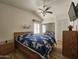 Comfortable bedroom with a ceiling fan, large bed, and mirrored closet doors at 8700 E University Dr # 953, Mesa, AZ 85207