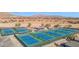 Overhead view of multiple blue tennis courts, showcasing community recreational facilities at 8700 E University Dr # 953, Mesa, AZ 85207