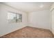 Bright bedroom featuring neutral carpet, white walls, blinds, and natural light at 914 N Cherry --, Mesa, AZ 85201