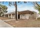 Charming home exterior with neutral stucco, awnings, brick accents and mature trees at 914 N Cherry --, Mesa, AZ 85201