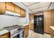 Well-lit kitchen with stainless steel appliances and abundant wood cabinetry for storage at 914 N Cherry --, Mesa, AZ 85201