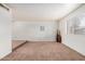 Spacious living room with neutral carpet and a window, offering ample space for furniture and decor at 914 N Cherry --, Mesa, AZ 85201