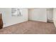 Inviting living room with plush carpeting and ample natural light from a large window at 914 N Cherry --, Mesa, AZ 85201