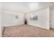 Bright living room featuring neutral carpet, a window letting in natural light, and clean white walls at 914 N Cherry --, Mesa, AZ 85201
