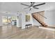 Bright living room with modern finishes, light wood floors, and stylish staircase at 930 W Mission Ln, Phoenix, AZ 85021