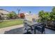 Backyard featuring a patio dining table, lush green grass, landscaping and a privacy fence at 10318 W Luke Ave, Glendale, AZ 85307