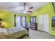 Bright bedroom featuring tile floors, ceiling fan, and access to the backyard through sliding glass door at 10318 W Luke Ave, Glendale, AZ 85307