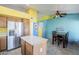 Kitchen with stainless steel refrigerator and view to dining room table at 10318 W Luke Ave, Glendale, AZ 85307