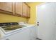 Bright laundry room with modern appliances and plenty of cabinet space at 10318 W Luke Ave, Glendale, AZ 85307