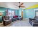 Cozy living room with comfortable seating, ceiling fan, and large window at 10318 W Luke Ave, Glendale, AZ 85307