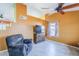 Comfortable living room with a ceiling fan, television, and cozy recliner on tile flooring at 10318 W Luke Ave, Glendale, AZ 85307