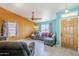 Inviting living room featuring tile floors, ceiling fan, colorful walls, and ample natural light at 10318 W Luke Ave, Glendale, AZ 85307