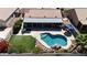 Aerial view of backyard oasis with pool, rock waterfall feature, patio, and artificial grass at 10318 W Luke Ave, Glendale, AZ 85307