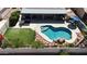 Aerial view of backyard oasis with pool, rock waterfall feature, patio, and artificial grass at 10318 W Luke Ave, Glendale, AZ 85307