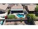 Aerial view of backyard oasis with pool, rock waterfall feature, patio, and artificial grass at 10318 W Luke Ave, Glendale, AZ 85307