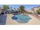 Beautiful backyard pool with waterfall feature, palm trees, and a muraled privacy wall at 10318 W Luke Ave, Glendale, AZ 85307