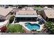 Aerial view of backyard oasis with pool, rock waterfall feature, patio, and artificial grass at 10318 W Luke Ave, Glendale, AZ 85307