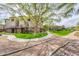 Exterior view of a condominium building, sidewalks, luscious grass, and large shade trees in the community at 14950 W Mountain View Blvd # 5312, Surprise, AZ 85374