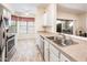 Bright kitchen featuring stainless steel appliances, dual sink, neutral countertops and backsplash, and open breakfast nook at 14950 W Mountain View Blvd # 5312, Surprise, AZ 85374