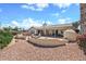 Expansive backyard featuring a patio, a fireplace, and desert landscaping at 15546 W Whitton Ave, Goodyear, AZ 85395