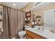 Cozy bathroom featuring a shower, a vanity with a sink, and earth-tone colors at 15546 W Whitton Ave, Goodyear, AZ 85395