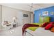 Bright bedroom featuring a blue accent wall, white trim, and neutral carpeting at 15546 W Whitton Ave, Goodyear, AZ 85395