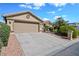 Home exterior featuring a neutral color scheme, desert landscaping, and a garage at 15546 W Whitton Ave, Goodyear, AZ 85395