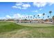 Scenic golf course view with lush green fairway and a tranquil lake, providing a picturesque backdrop at 15546 W Whitton Ave, Goodyear, AZ 85395