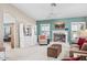 Cozy living room featuring a fireplace, vaulted ceilings, and built-in shelving at 15546 W Whitton Ave, Goodyear, AZ 85395