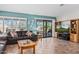 Comfortable living room with tile floors, a leather couch and sliding doors to the patio at 15546 W Whitton Ave, Goodyear, AZ 85395