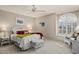 Serene bedroom featuring natural light, a ceiling fan, and comfortable seating at 15546 W Whitton Ave, Goodyear, AZ 85395