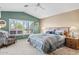 Serene main bedroom featuring a vaulted ceiling, and a cozy sitting area by the window at 15546 W Whitton Ave, Goodyear, AZ 85395