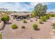 This backyard features desert landscaping, a covered patio, and desert views at 16406 W Peppertree Ct, Surprise, AZ 85387