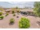 This backyard offers desert landscaping and a covered patio at 16406 W Peppertree Ct, Surprise, AZ 85387