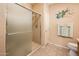 Bathroom featuring glass enclosed shower with decorative wall art at 16406 W Peppertree Ct, Surprise, AZ 85387